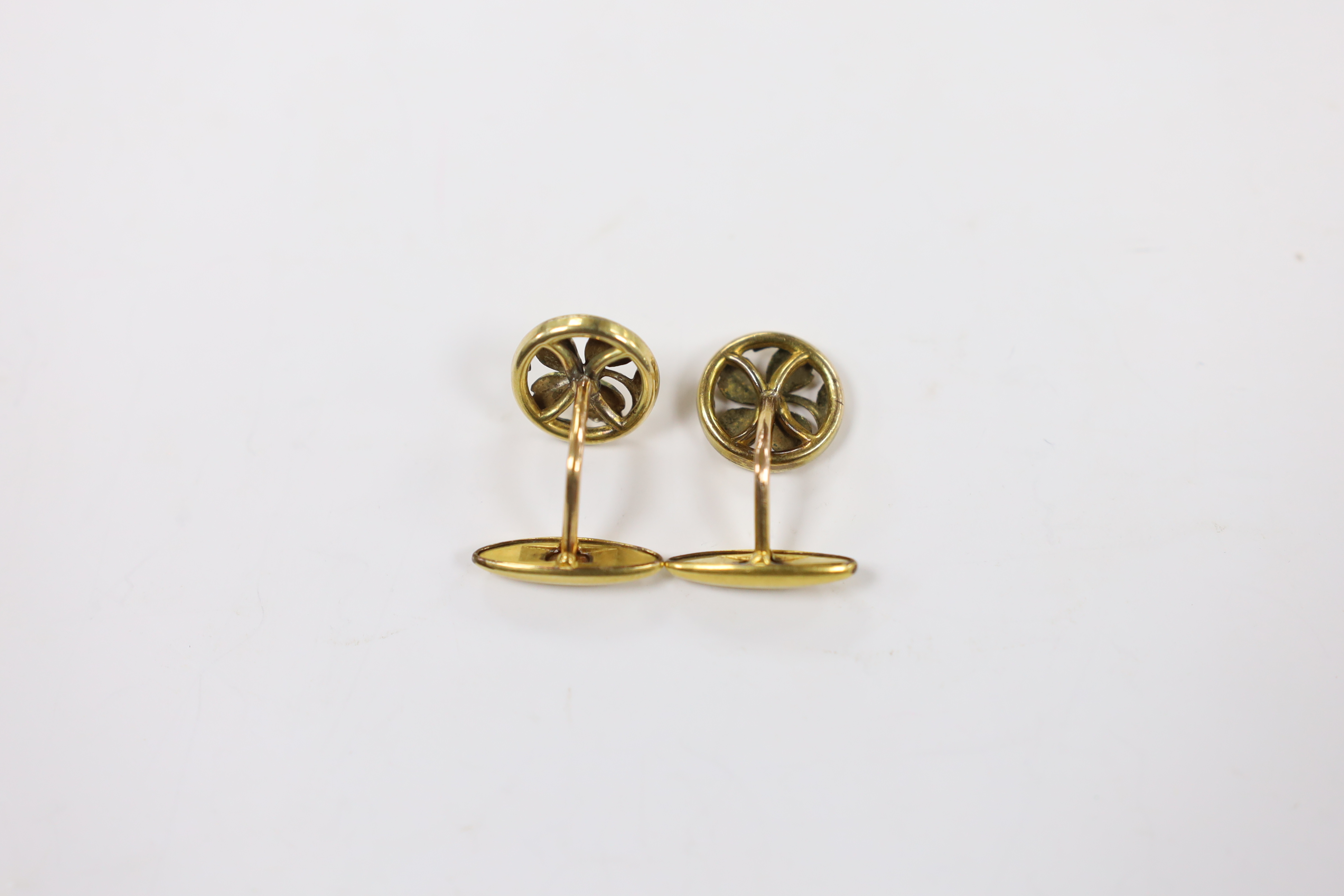 A pair of continental yellow metal overlaid circular cufflinks, of pierced foliate form, 14mm.
